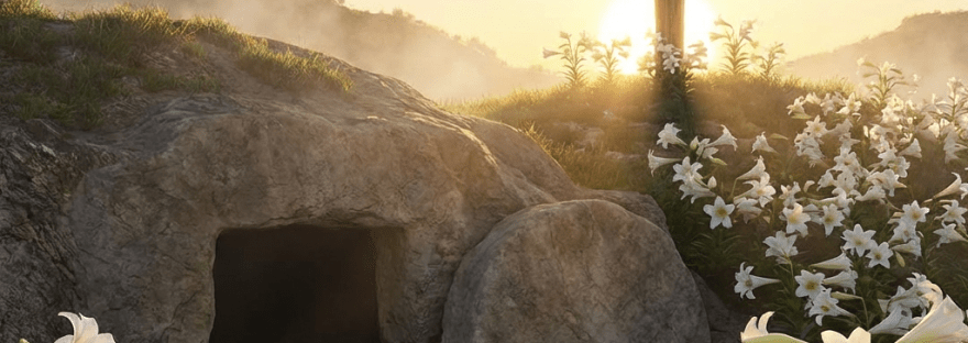 An open stone tomb and a wooden cross on a hill during a bright sunrise.